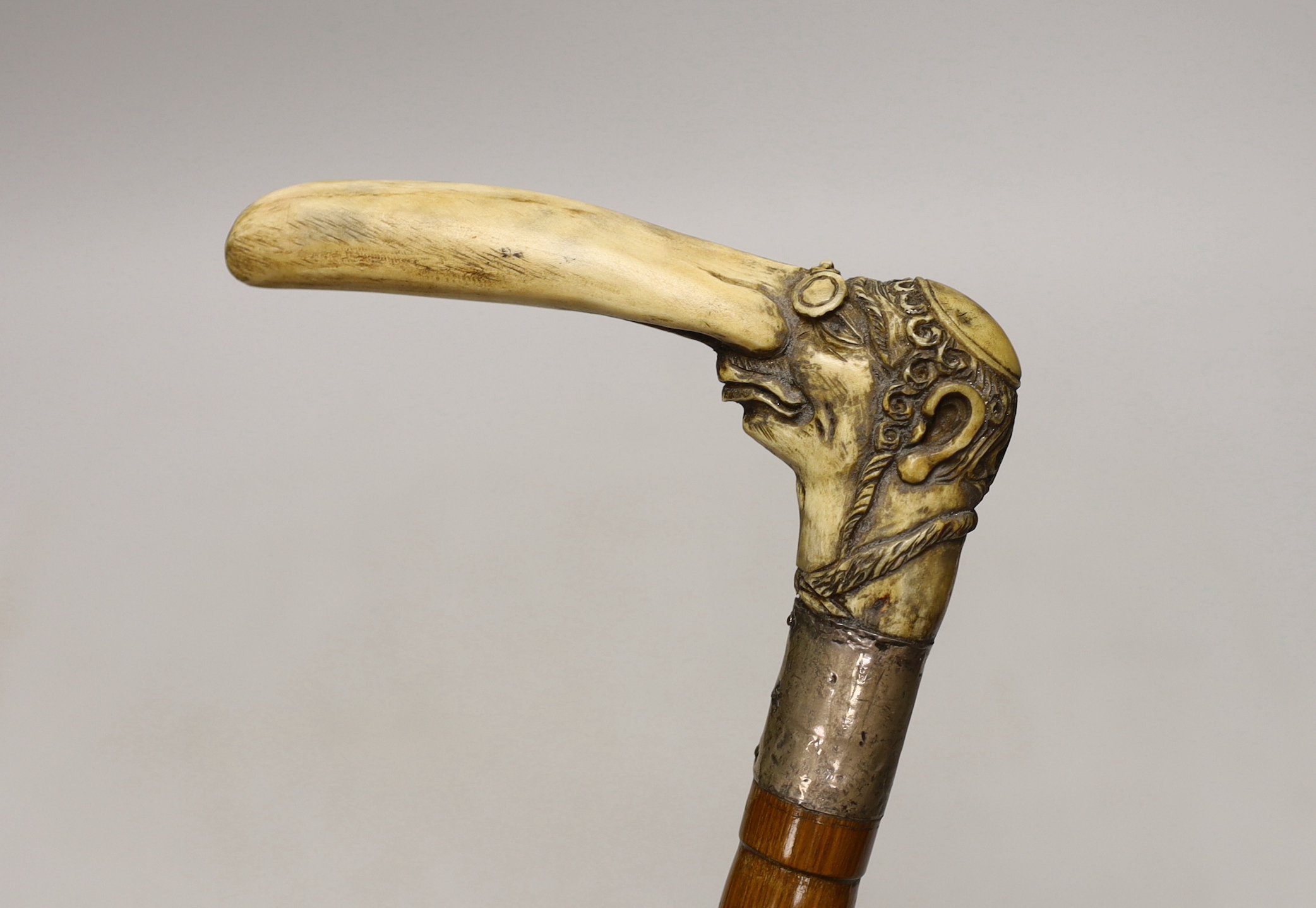 A stag horn handled walking stick with Jewish caricature, 81cm